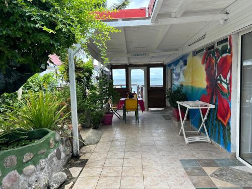a patio with a mural on the side of a building at Sunrise in Le Moule