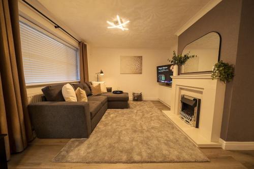 a living room with a couch and a fireplace at Entire Bungalow in Rawmarsh in Rawmarsh