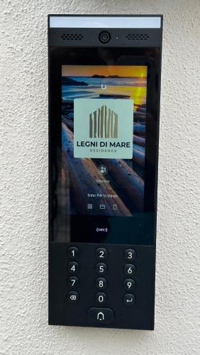 a cell phone is attached to a wall at Legni di mare residence in San Salvatore