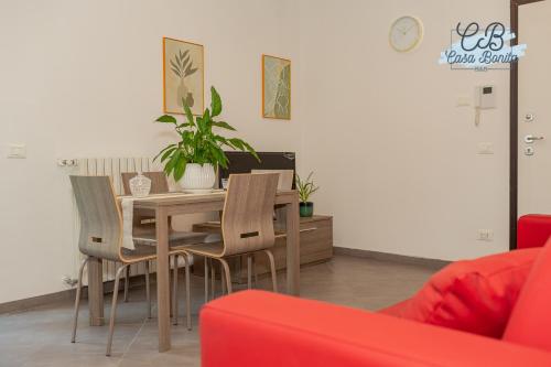 a dining room with a wooden table and chairs at Casa Bonita Rho in Rho