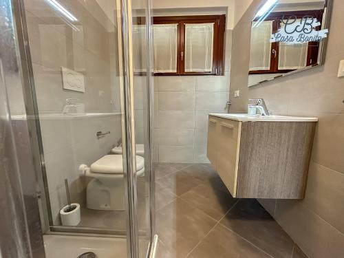 a bathroom with a shower and a toilet and a sink at Casa Bonita Rho in Rho