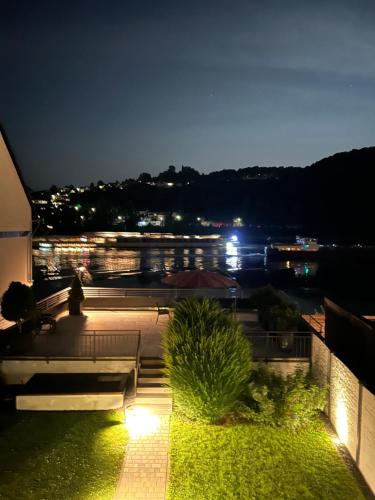 a view of a city at night from a balcony at Haus Rheinterrasse in Koblenz