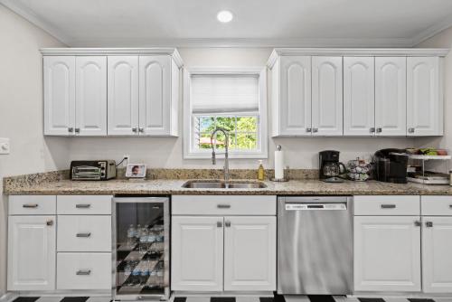 a kitchen with white cabinets and a sink at Casa de Lorie the ultimate vacation home in Ooltewah