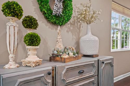 a table with vases and plants on a wall at Casa de Lorie the ultimate vacation home in Ooltewah
