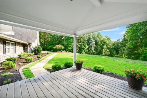 an outdoor deck with a white pergola at Casa de Lorie the ultimate vacation home in Ooltewah