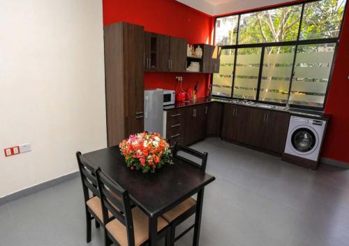a kitchen with a table with flowers on it at Hillside Retreat in Kandy