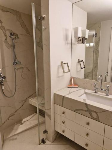 a bathroom with a shower and a sink and a mirror at aqueduct villa cesarea jacuzzi in Caesarea