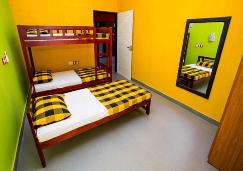a bedroom with two bunk beds and a mirror at Hillside Retreat in Kandy
