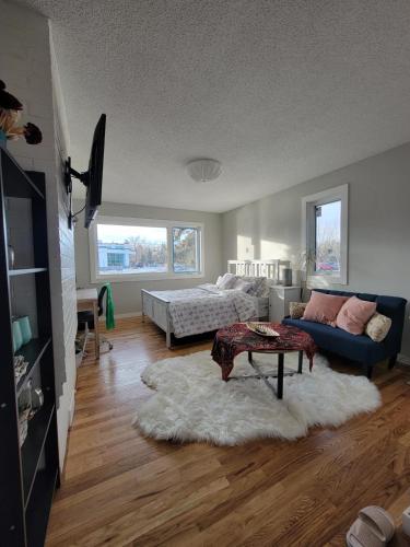 a living room with a couch and a table at Heart to Downtown - Bright and Sunny Ultra Premium Queen bedroom in Calgary
