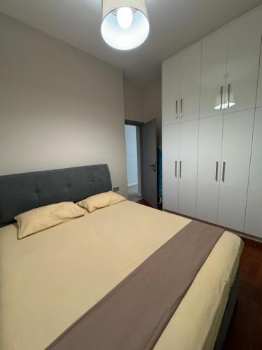 a bedroom with a large bed and white cabinets at A Modern & Homely 1BR Apartment in Chios
