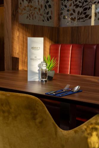a table in a restaurant with a menu on it at Radisson Blu Hotel, Durham in Durham