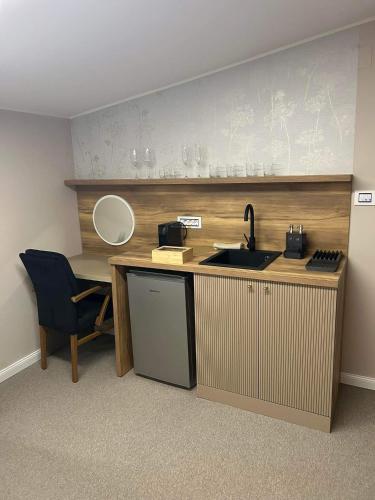 a kitchen with a sink and a counter with a mirror at Face 2 Center SUBOTICA in Subotica