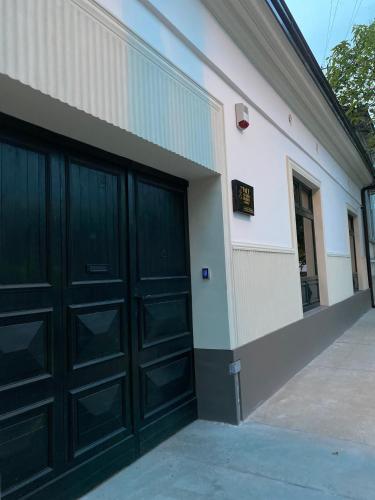two sets of garage doors on the side of a building at Face 2 Center SUBOTICA in Subotica