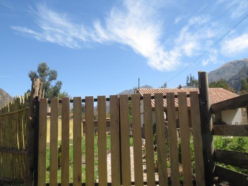 a wooden fence in front of a house at casa de campo-arin in Huaran