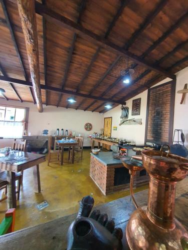 a large room with tables and chairs in a building at Pousada Villa di Lavras in Lavras Novas