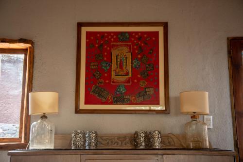 a painting on a wall with two bottles on a table at San Ignacio Estancia Andina in El Challao