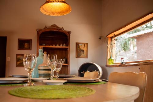 a dining room with a table with wine glasses at San Ignacio Estancia Andina in El Challao