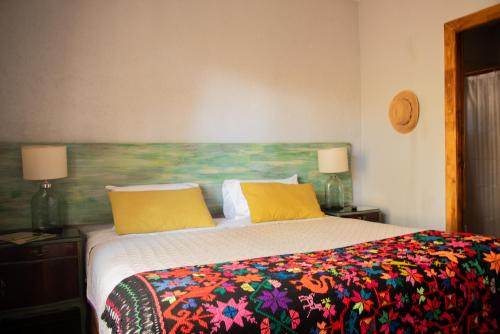 a bedroom with a bed with a colorful blanket at San Ignacio Estancia Andina in El Challao