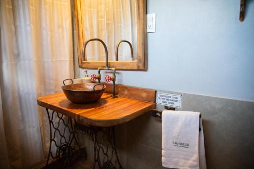 a bathroom with a wooden sink and a mirror at San Ignacio Estancia Andina in El Challao