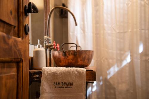 a bathroom with a sink and a bowl on a towel at San Ignacio Estancia Andina in El Challao