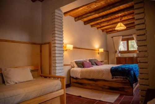 a bedroom with two beds and a window at San Ignacio Estancia Andina in El Challao