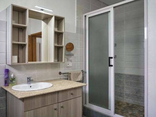 a bathroom with a sink and a shower at Villa Alexis - Location de vacances à Trou aux Biches in Trou aux Biches