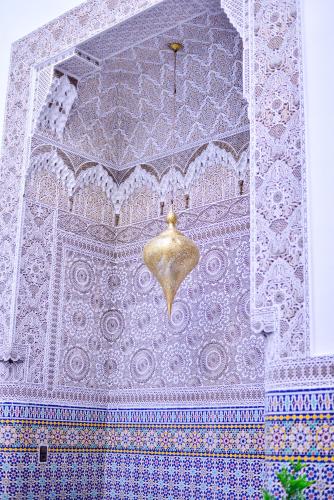a ceiling of a mosque with a gold fixture at Riad Dilar Fes & Spa in Fès