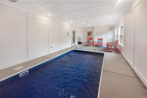 an indoor swimming pool in a room with blue water at New! Indoor Pool/PS 5/Hot tub/Parkway in Pigeon Forge