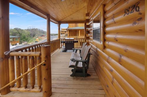 a porch of a cabin with two benches on it at New! Indoor Pool/PS 5/Hot tub/Parkway in Pigeon Forge