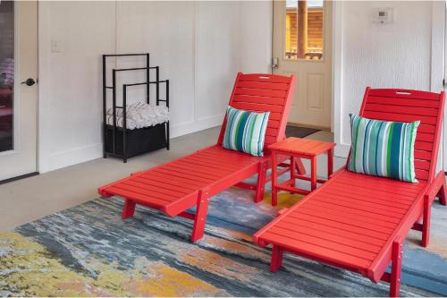 two red benches sitting in a room with a rug at New! Indoor Pool/PS 5/Hot tub/Parkway in Pigeon Forge