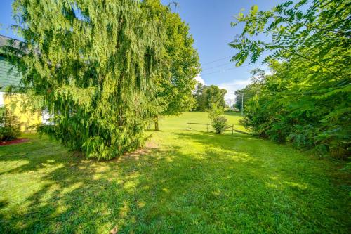 a weeping willow tree in a yard at Walk to Chautauqua Lake Mayville Getaway! in Mayville