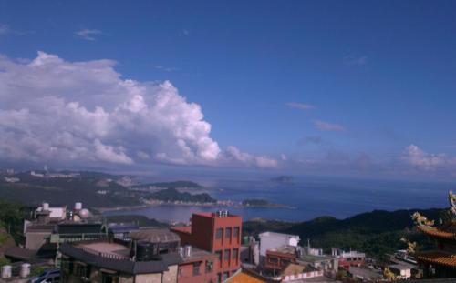 a view of a city with a lake in the distance at A-HOME in Jiufen