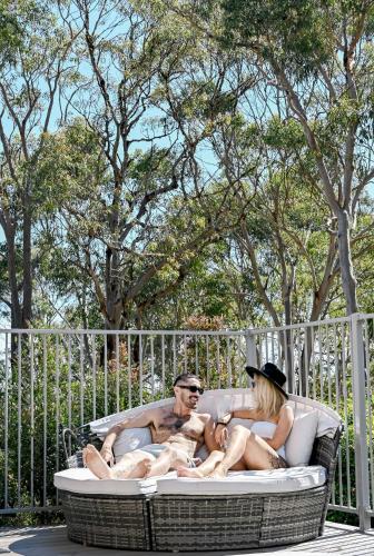 a group of people sitting in a hot tub at The Harmony Retreat in Murrays Beach