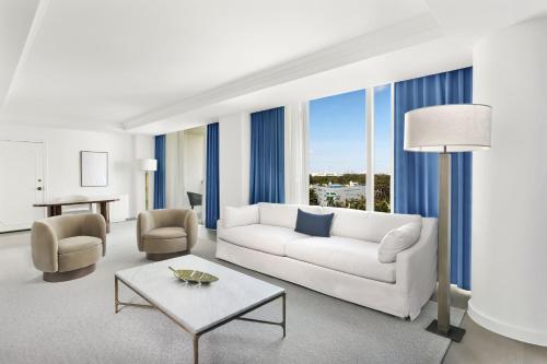 a living room with a white couch and a table at The Ritz-Carlton Coconut Grove, Miami in Miami