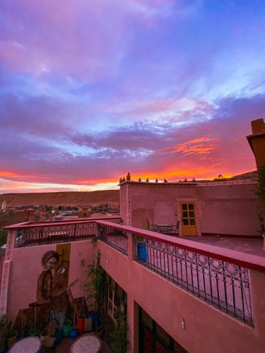 a view of a sunset from a balcony of a building at Auberge Ayouze in Aït Ben Haddou