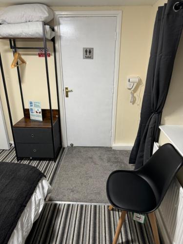a room with a bed and a desk and a chair at Ye Olde Black Cross in Bromsgrove