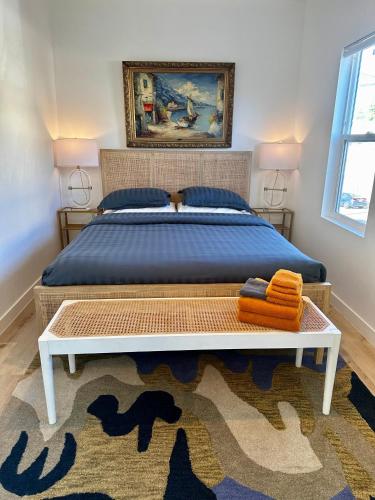 a bedroom with a bed with a blue bedspread and a rug at Modern, Remodeled Echo Park House-Walk to Sunset Blvd, Dodgers Stadium, Shops, Bars, Restaurants, Lake, Concerts in Los Angeles