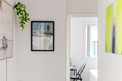 a hallway with a door with a picture on the wall at Double Room - Quaint Spot in Marayong - Centrally Located - Shared Bathroom in Blacktown
