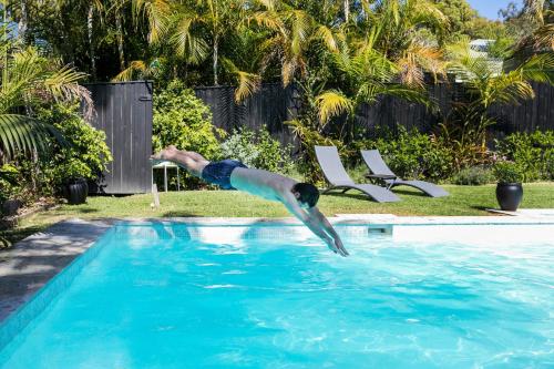 a man is diving into a swimming pool at 'the Governor Ii' - Designer Wonderland, Avalon in Avalon