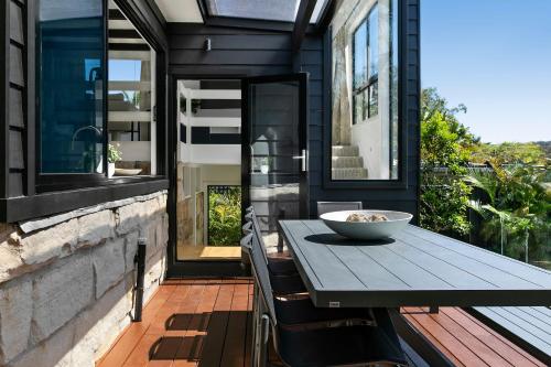 a table on a balcony with a bowl on it at 'the Governor Ii' - Designer Wonderland, Avalon in Avalon