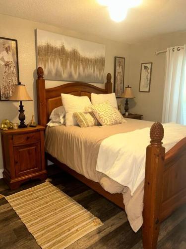 a bedroom with a large bed with white sheets and pillows at Nataj suites at Tampa in Tampa