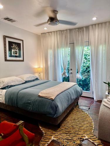 a bedroom with a bed and a large window at Spacious Resort Getaway @ Echo Park Ranch - Luxury indoor/ outdoor home steps from Sunset Blvd, Echo Park Lake, Dodgers Stadium in Los Angeles