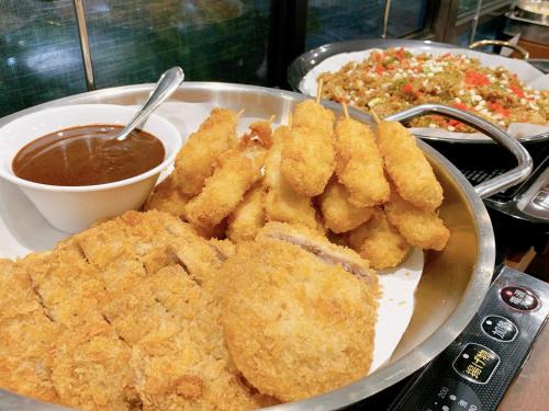a plate of food with fried onion rings and dips at Green Rich Hotel Kobe Sannomiya (Artificial hot spring Futamata Yunohana) in Kobe