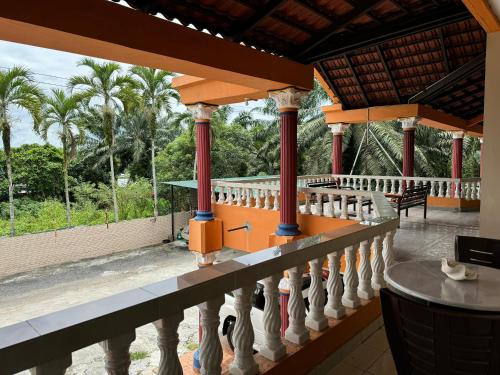 a view from the balcony of a resort with palm trees at Myoldhouse in Lahad Datu