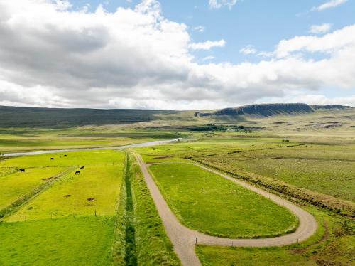 an aerial view of a field with a dirt road at Laugavellir - House in Kleppjárnsreykir