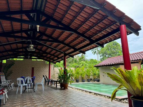 a wooden pergola over a patio with a pool at Myoldhouse in Lahad Datu