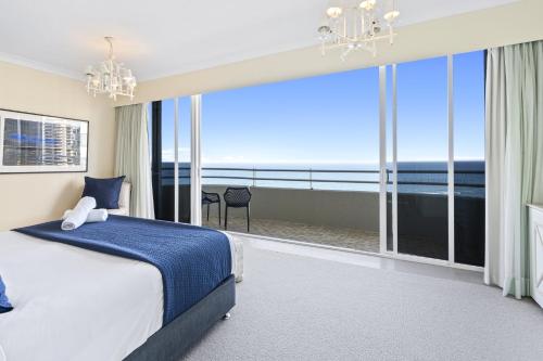 a bedroom with a bed and a view of the ocean at Zenith Apartments - Q Stay in Gold Coast