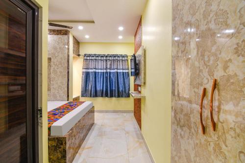 a small room with a bed and a window at Hotel Divine Chariot in kolkata