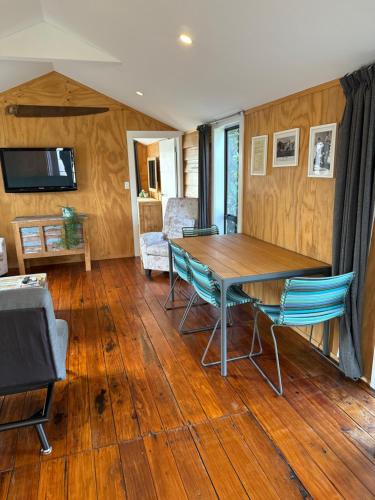a dining room with a table and chairs at Historic Barn Loft - Private & Spacious in Tauranga