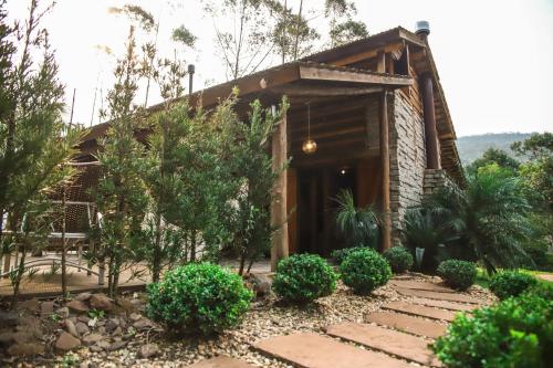 a house with a pathway leading to the front door at Chalé Casa de Pedra, Vivenda Serra Velha, Chalés de Montanha in Timbe do Sul